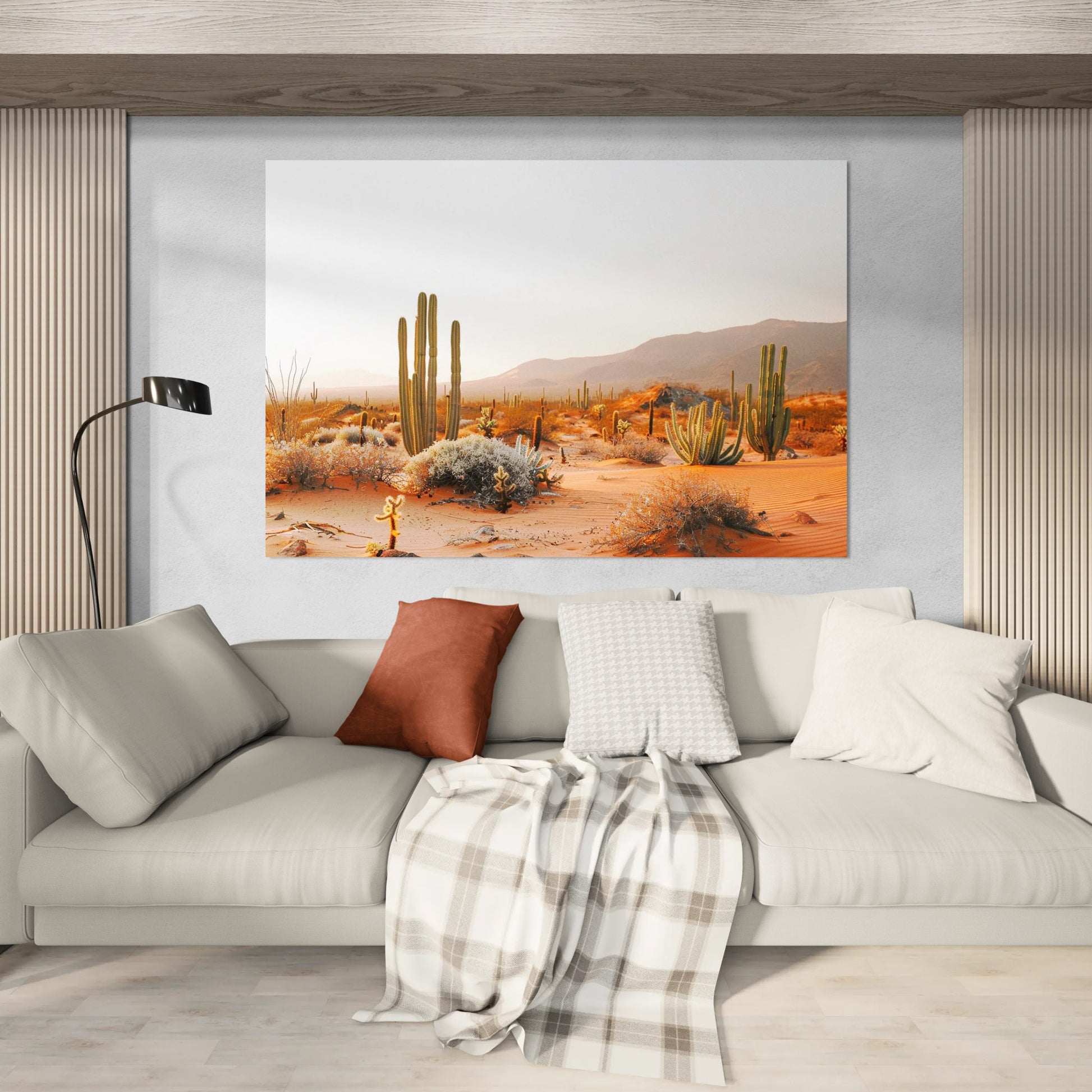 Warm tones desert scene cactus landscape canvas wall art displayed above a cozy modern sofa with neutral pillows