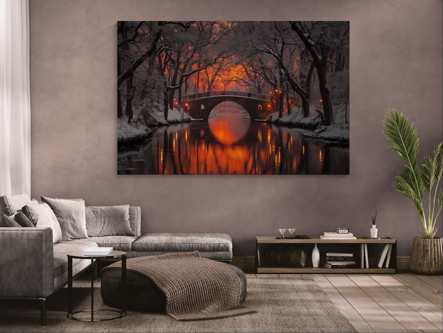 winter canvas wall art with glowing bridge reflected in water, displayed in a modern living room with neutral walls and wooden floor.