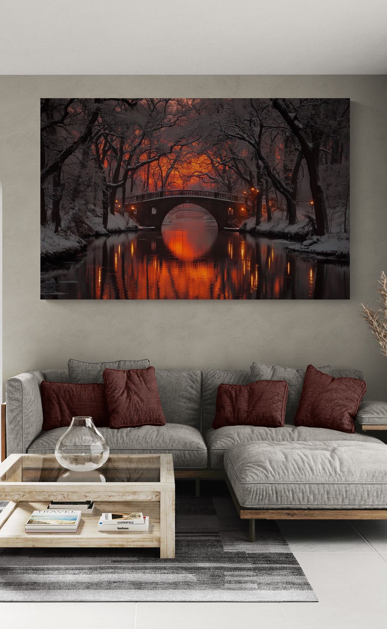 winter canvas wall art featuring a glowing bridge reflected in water, styled above a modern sofa in a warm, neutral living room interior